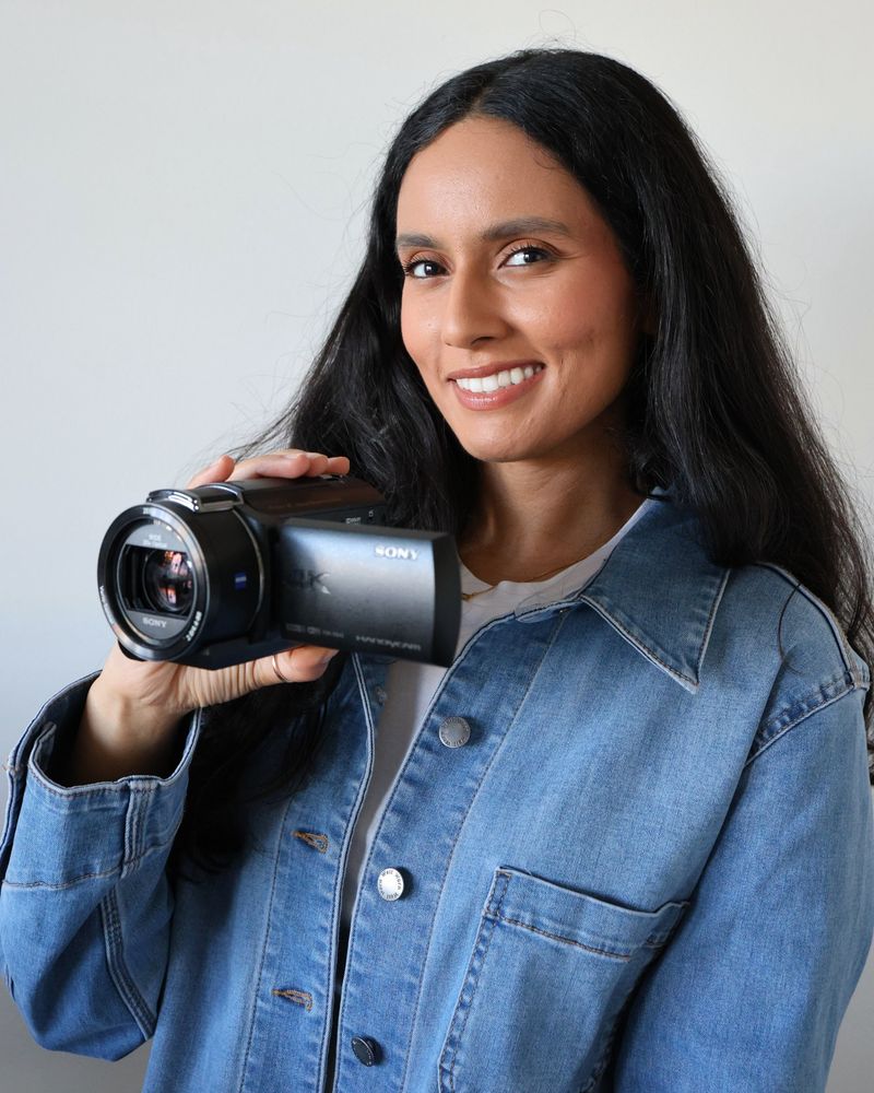 Hanna, founder of Recorda, smiling and holding a Sony 4K camcorder